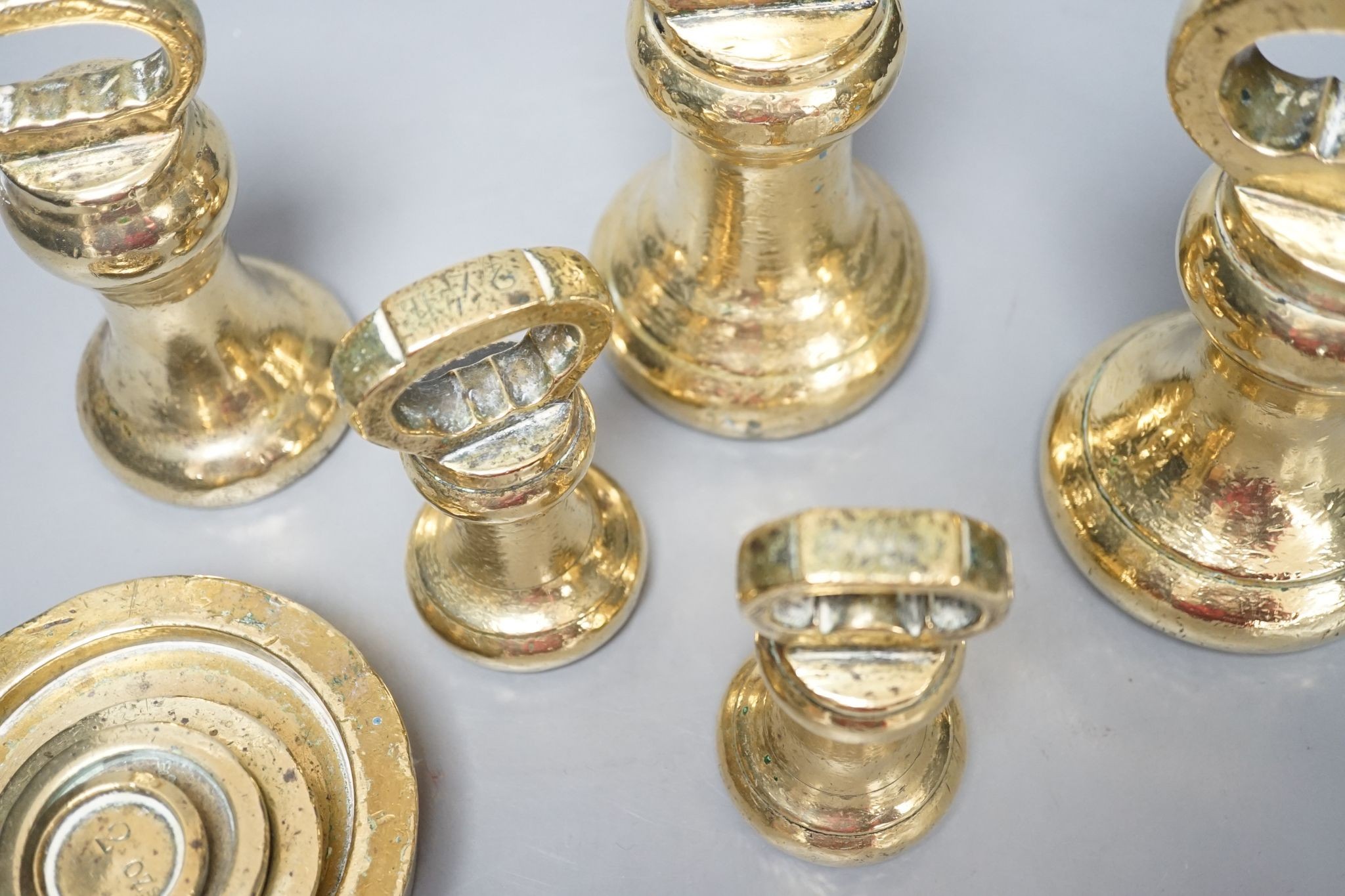 A set of 5 Victorian graduated cast brass bell weights and 3 graduated cast brass disc weights (8) 18cm